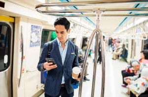 Business person on train on phone